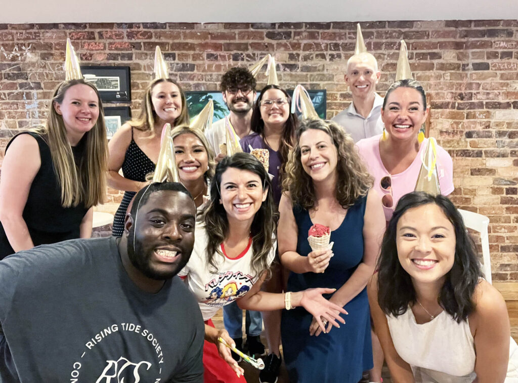 Rising Tide Greenville and Ashville group photo, members wearing party hats