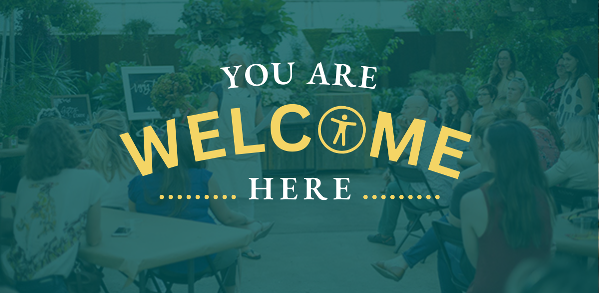 You are welcome here text with accessibility icon overlaying image of a Rising Tide meetup